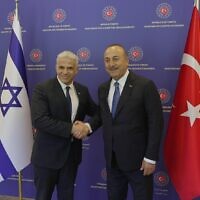 Foreign Minister Yair Lapid (L) meets with his Turkish counterpart, Mevlut Cavusoglu, in Ankara on June 23, 2022. (Boaz Oppenheim/GPO)