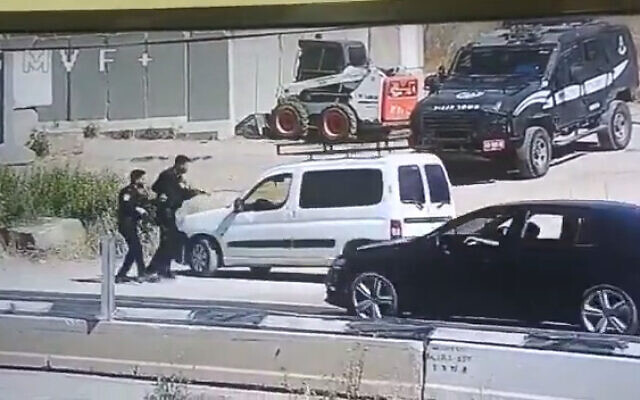 Police question a Palestinian man near the West Bank town of al-Fawwar, south of Hebron on June 8, 2022. The suspect snatched the rifle of one of the officers before driving off. (Screenshot: Twitter)