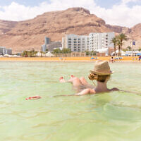 A woman floats in the Dead Sea at Ein Bokek. Illustrative. (Subbotsky via iStock by Getty Images)
