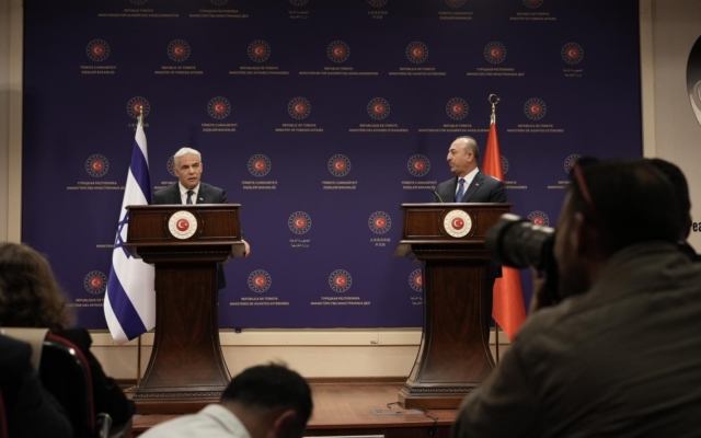 Foreign Minister Yair Lapid (left) speaks alongside his Turkish counterpart, Mevlut Cavusoglu, in Ankara on June 23, 2022. (Boaz Oppenheim/GPO)