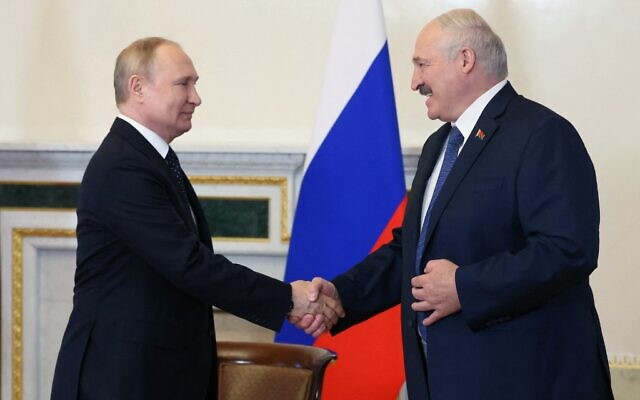 Russian President Vladimir Putin (L) shakes hands with his Belarusian counterpart Alexander Lukashenko during their meeting in Saint Petersburg, on June 25, 2022. (Mikhail Metzel/Sputnik/AFP)