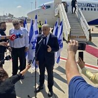 Prime Minister Yair Lapid speaks to the press ahead of his first overseas trip as PM, to Paris, at Ben Gurion Airport on July 5, 2022. (Guillaume LAVALLÉE / AFP)