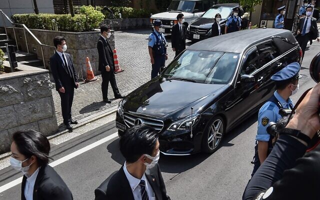 A hearse transporting the body of former Japanese prime minister Shinzo Abe arrives at his residence in Tokyo on July 9, 2022. (Kazuhiro Nogi/AFP)