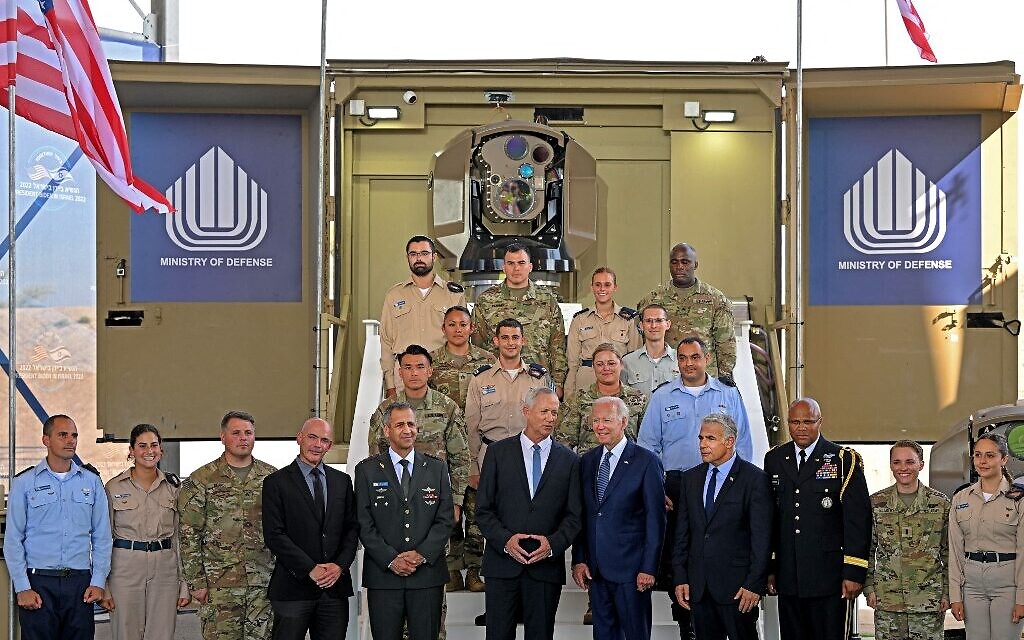 US President Joe Biden (5th R) listens to Israeli Defense Minister Benny Gantz (C), as they tour the Iron Beam laser air defense system at Ben Gurion Airport near Tel Aviv on July 13, 2022 with Prime Minister Yair Lapid (4th R), Israeli expert on technology and innovation Danny Gold (4th L), IDF chief Aviv Kohavi (5th L) and US Defense Attaché in Israel, Brigadier General Shawn A. Harris (3r R). (MANDEL NGAN / AFP)