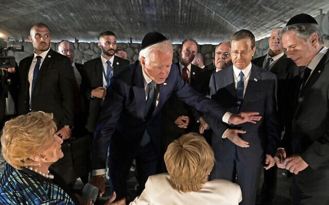 US President Joe Biden speaks to Holocaust survivors Giselle Cycowicz (seated R) and Rena Quint (seated L) as US Secretary of State Antony Blinken (R) and Israel's President Isaac Herzog (2nd R) look on during a ceremony at the Hall of Remembrance of the Yad Vashem Holocaust Memorial museum in Jerusalem, on July 13, 2022. (DEBBIE HILL / POOL / AFP)