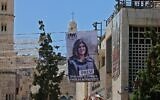 Banners depicting slain Palestinian-American journalist Shireen Abu Akleh hang on a building overlooking the Church of the Nativity in Bethlehem in the West Bank, on July 14, 2022. (Ahmad Gharabli/AFP)
