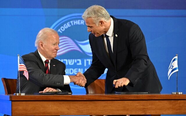 US President Joe Biden (L) and Israel's Prime Minister Yair Lapid shake hands after signinig the Jerusalem Declaration before the start of a joint press conference in Jerusalem, on July 14, 2022. (Mandel Ngan/AFP)