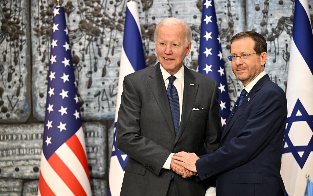 US President Joe Biden shakes hands with President Isaac Herzog (R) at the President's Residence in Jerusalem on July 14, 2022. (Photo by MANDEL NGAN / AFP)
