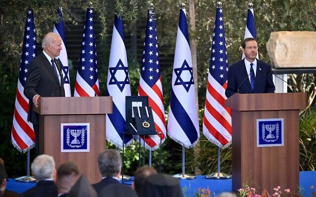 President Isaac Herzog (R) speaks ahead of presenting US President Joe Biden with the Presidential Medal of Honor at the President's Residence in Jerusalem on July 14, 2022. (Photo by MANDEL NGAN / AFP)