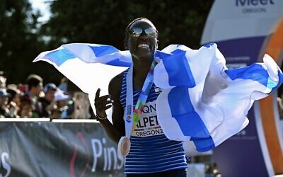 Bronze medalist Lonah Chemtai Salpeter of Israel celebrates after crossing the finish line in the women's marathon final, during the World Athletics Championships in Eugene, Oregon on July 18, 2022. (Jim WATSON / AFP)