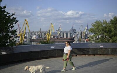 A woman walks in a park with her dog in Odesa, on July 20, 2022, amid the Russian invasion of Ukraine. (Bulent Kilic/AFP)