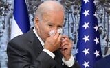 In this photo taken on July 14, 2022, US President Joe Biden wipes his nose after signing the guest book while visiting Israel's President Isaac Herzog at Beit HaNassi, the presidential residence in Jerusalem. (MANDEL NGAN / AFP)