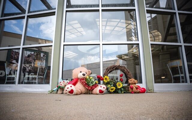 Teddy bears and flowers are sit as a memorial outside of the Greenwood Park Mall food court on July 18, 2022 in Greenwood, Indiana. (Jon Cherry/Getty Images/AFP)