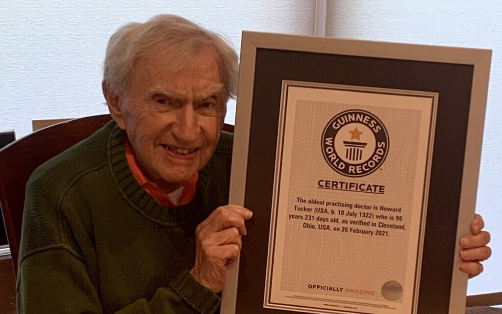 Dr. Howard Tucker holds the Guiness World Records certificate recognizing him as the oldest active physician in the United States. (Courtesy Tucker/ via JTA)