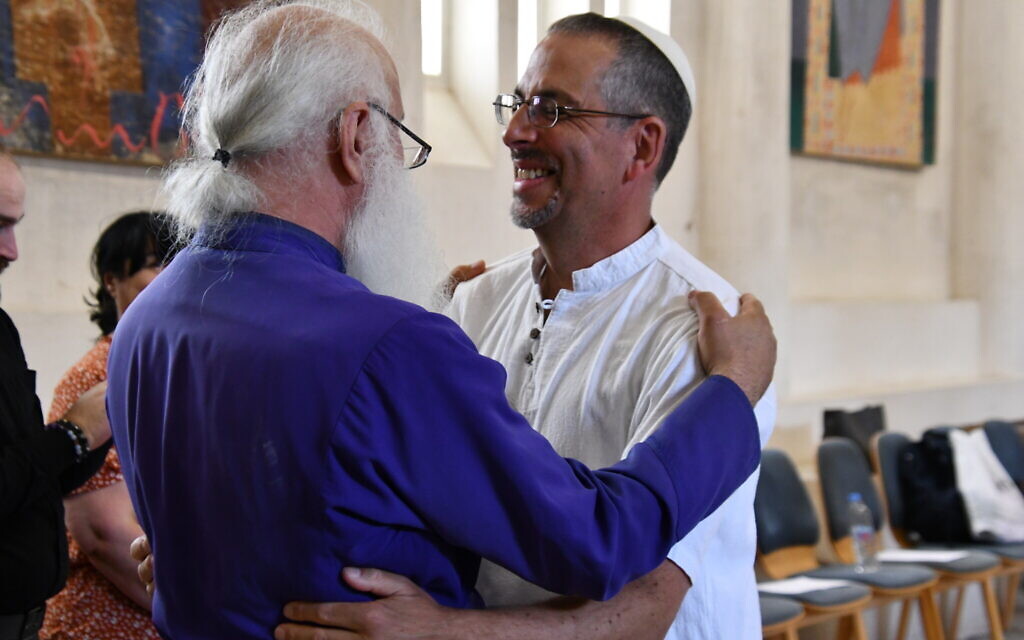 Rabbi Golan Ben-Chorin and Bishop Malkhaz Songulashvili embrace in the Peace Cathedral. (Nano Saralishvili/ via JTA)