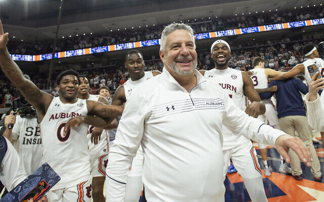 Head coach Bruce Pearl of the Auburn Tigers celebrates with his team after defeating the Alabama Crimson Tide at Auburn Arena on February 01, 2022 in Auburn, Alabama (Michael Chang/Getty Images via JTA)