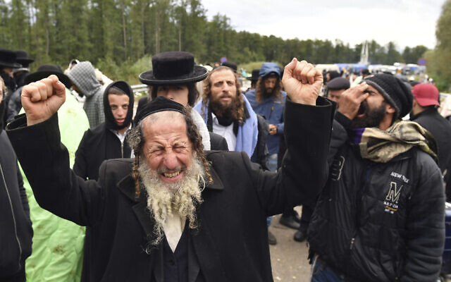 A Hasidic Jewish pilgrim reacts as he joins others, in front of Ukrainian border guards at the checkpoint Novaya Guta near Novaya Guta, Belarus, Friday, Sept. 18, 2020. (AP)