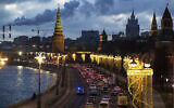 Traffic on a bank of the Moskva River outside the Kremlin in Moscow, Russia, December 23, 2020. (Pavel Golovkin/AP)