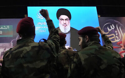File: Hezbollah fighters raise their hands as their leader Hassan Nasrallah speaks via a video link during a rally to mark Jerusalem day or Al-Quds day, in a southern suburb of Beirut, Lebanon, April 29, 2022. (AP Photo/Hassan Ammar)