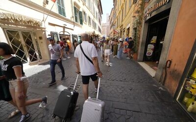 Tourists walk in downtown Rome, Monday, June 20, 2022. (AP Photo/Andrew Medichini)