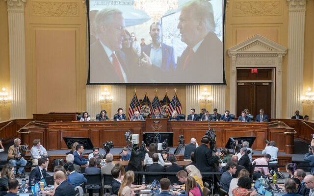 An image of former president Donald Trump talking to his chief of staff Mark Meadows is seen, as Cassidy Hutchinson, former aide to Trump White House chief of staff Mark Meadows, testifies, as the House select committee investigating the January 6 riot holds a hearing at the Capitol in Washington, June 28, 2022. (Sean Thew/Pool via AP)