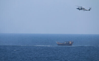 Illustrative: A US Navy Seahawk helicopter flies over a stateless dhow later found to be carrying a hidden arms shipment in the Arabian Sea, May 6, 2021. (US Navy via AP)