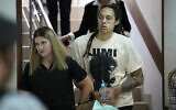 WNBA star and two-time Olympic gold medalist Brittney Griner is escorted to a courtroom for a hearing, in Khimki just outside Moscow, Russia, July 1, 2022. (AP Photo/Alexander Zemlianichenko)