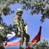 Russian soldiers set a Russian national flag and a replica of the Victory banner after capturing the eastern village of Bilohorivka which is now a territory under the Government of the Luhansk People's Republic control, eastern Ukraine,  July 3, 2022. (Russian Defense Ministry Press Service via AP)