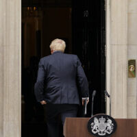 Prime Minister Boris Johnson enters 10 Downing Street, after reading a statement in London, July 7, 2022. (AP Photo/Alberto Pezzali)