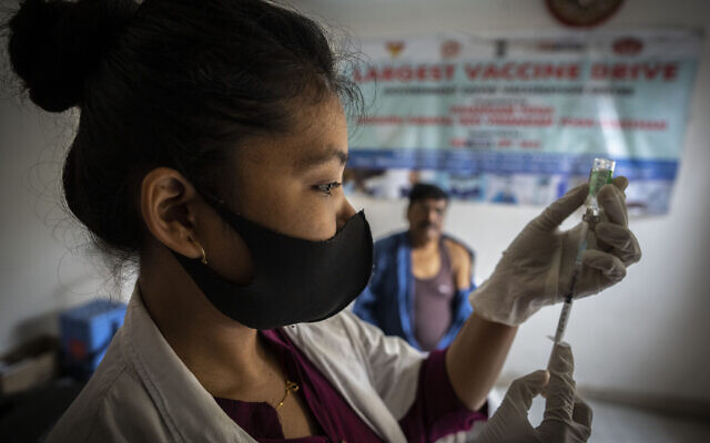 A nurse prepares to administer vaccine for COVID-19 at a private vaccination center in Gauhati, India, April 10, 2022. (Anupam Nath/AP)