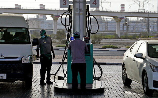 A gas station attendant fills a gas tank in Dubai, United Arab Emirates, July 10, 2022. AP Photo/Kamran Jebreili)