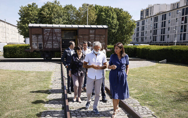 Paris mayor Anne Hidalgo, right, talks to Jacques Fredj, head of the Shoah Memorial ,as they leave the train car symbolizing the Drancy camp, July 12, 2022 in Drancy, outside Paris (AP Photo/Thomas Padilla)