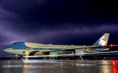 The sky illuminated by lighting at Andrews Air Force Base, Maryland, as Air Force One is seen in the foreground ahead of President Joe Biden departing for a trip to Israel and Saudi Arabia, July 12, 2022. (AP Photo/Gemunu Amarasinghe)
