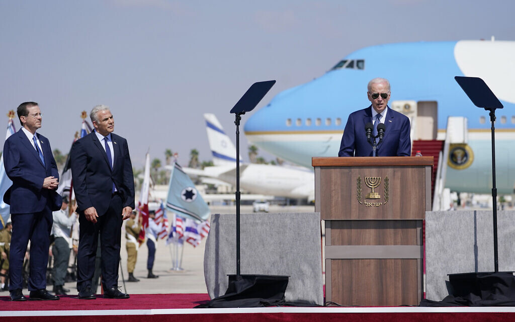 President Joe Biden speaks after arriving at Ben Gurion Airport, Wednesday, July 13, 2022, as Israeli Prime Minister Yair Lapid, second left, and President Isaac Herzog, left, look on. (AP Photo/Evan Vucci)
