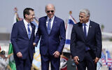 US President Joe Biden stands with Prime Minister Yair Lapid, right, and President Isaac Herzog, left, after arriving at Ben Gurion Airport, July 13, 2022. (AP Photo/Evan Vucci)
