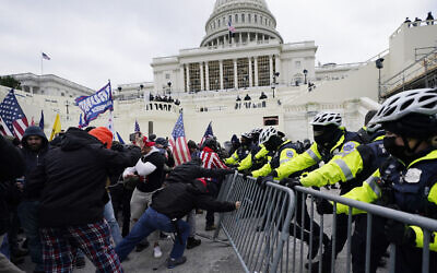 Insurrectionists loyal to then US president Donald Trump try to break through a police barrier, January 6, 2021, at the Capitol in Washington. (Julio Cortez/AP)