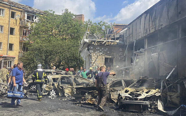 Rescuers at the scene of building damaged by shelling, in Vinnytsia, Ukraine, July 14, 2022. (Ukrainian Emergency Service via AP)