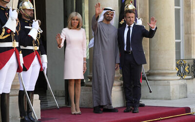 France's President Emmanuel Macron, right, and his wife Brigitte Macron, left, welcome United Arab Emirates' President Sheikh Mohammed Bin Zayed at the Elysee Palace in Paris, July 18, 2022. (AP Photo/ Michel Euler)