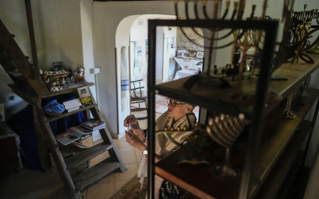 Rabbi Barbara Aiello shows her collection of religious items in the 'Ner Tamid del Sud' synagogue in Serrastretta, southern Italy, July 8, 2022  (AP Photo/Andrew Medichini)