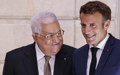 French President Emmanuel Macron, right, and Palestinian Authority President Mahmoud Abbas arrive for a meeting at the Elysee Palace in Paris, July 20, 2022. (Ludovic Marin/Pool via AP )