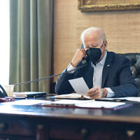 In this photo provided by the White House, US President Joe Biden talks on the phone with his national security team from the Treaty Room in the residence of the White House in Washington, July 22, 2022. (Adam Schultz/The White House via AP)