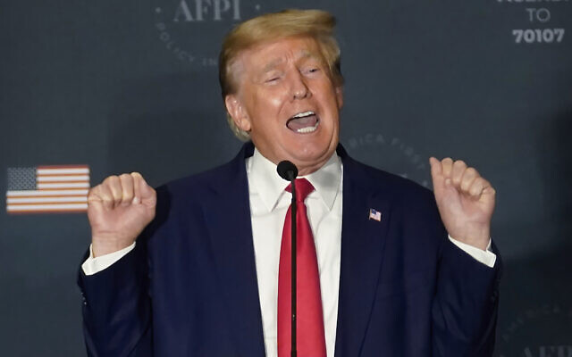 Former President Donald Trump talks about lifting weights as he speaks at an America First Policy Institute agenda summit at the Marriott Marquis in Washington, Tuesday, July 26, 2022. (AP/Andrew Harnik)