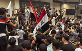 Iraqi protesters demonstrate inside the country's parliament in Baghdad, Iraq, Wednesday, July. 27, 2022.  (AP/Ali Jabar)
