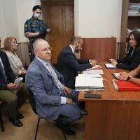 Lawyer Andrei Grishayev, foreground left, and his colleagues prepare to attend a preliminary hearing of the Russian claim to liquidate the Jewish Agency for Israel, in the Basmanny District Court in Moscow, Russia, Thursday, July 28, 2022. (AP/Alexander Zemlianichenko)