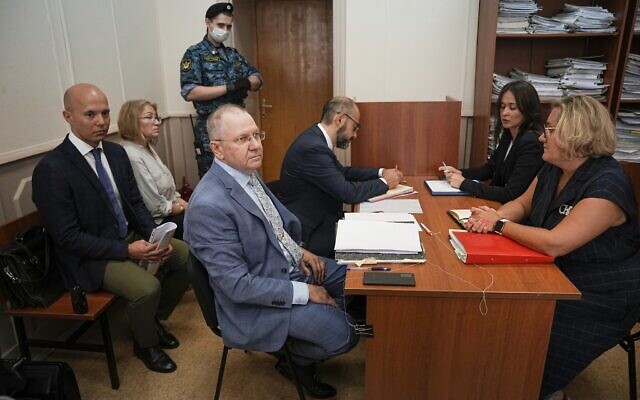 Lawyer Andrei Grishayev, foreground left, and his colleagues prepare to attend a preliminary hearing of the Russian claim to liquidate the Jewish Agency for Israel, in the Basmanny District Court in Moscow, Russia, Thursday, July 28, 2022. (AP/Alexander Zemlianichenko)