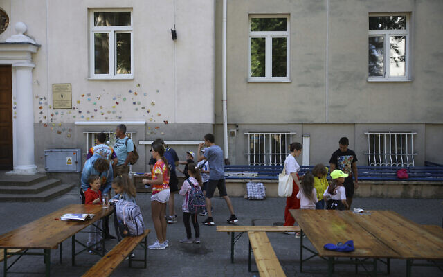 Ukrainian refugee children gather outside the Lauder Morasha Jewish school in Warsaw, Poland, Thursday, July 28, 2022. (AP Photo/Michal Dyjuk)