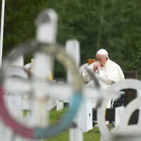 Pope Francis prays in a cemetery at the former residential school, in Maskwacis, near Edmonton, Canada, Monday, July 25, 2022. Pope Francis crisscrossed Canada this week delivering long overdue apologies to the country's Indigenous groups for the decades of abuses and cultural destruction they suffered at Catholic Church-run residential schools. (AP Photo/Gregorio Borgia)