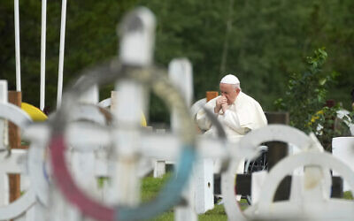 Pope Francis prays in a cemetery at the former residential school, in Maskwacis, near Edmonton, Canada, Monday, July 25, 2022. Pope Francis crisscrossed Canada this week delivering long overdue apologies to the country's Indigenous groups for the decades of abuses and cultural destruction they suffered at Catholic Church-run residential schools. (AP Photo/Gregorio Borgia)