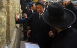 Japanese Prime Minister Shinzo Abe touches the stones of the Western Wall during his visit to Jerusalem's Old City, Jan. 19, 2015. (AP Photo/Mahmoud Illean)