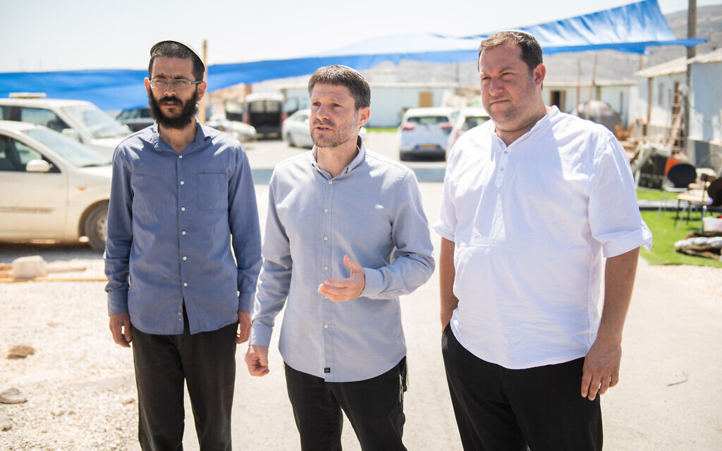 Head of the Religious Zionist Party MK Bezalel Smotrich, center, visits the illegal settlement outpost of Evyatar, in the West Bank, together with Nachala Settlement Movement leader director Tzvi Elimelech Sharbaf and Samaria Regional Council head Yossi Dagan, on June 27, 2021. (Sraya Diamant/Flash90)